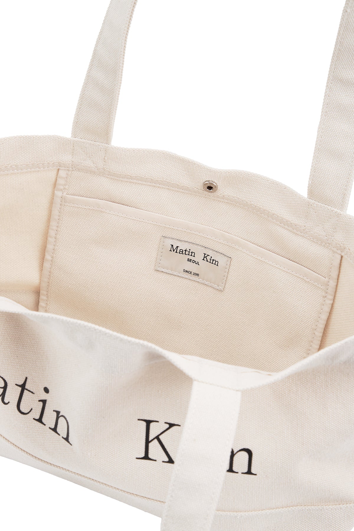 matinkim MATIN LOGO CANVAS WIDE SHOULDER BAG IN IVORY
