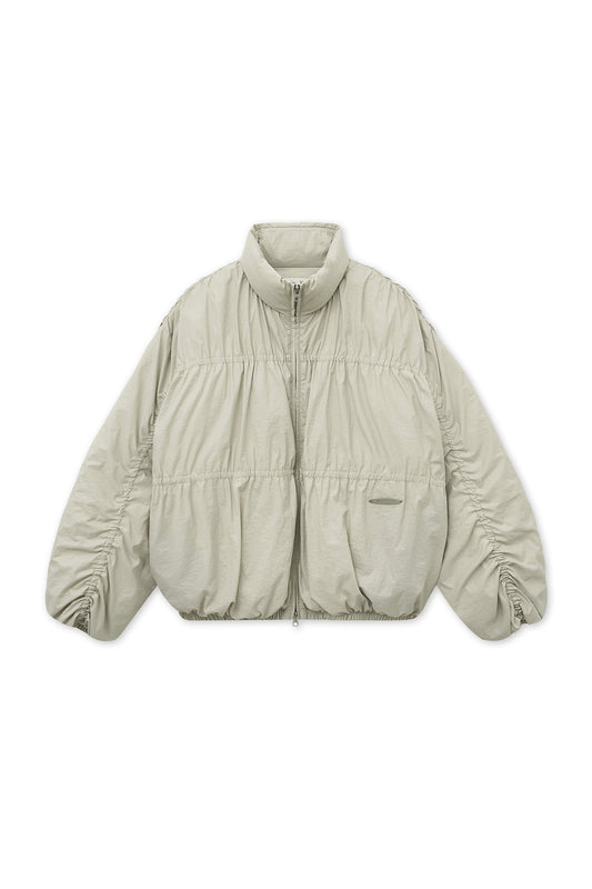 matinkim HIGH NECK SHIRRING DOWN JUMPER IN LIGHT BEIGE