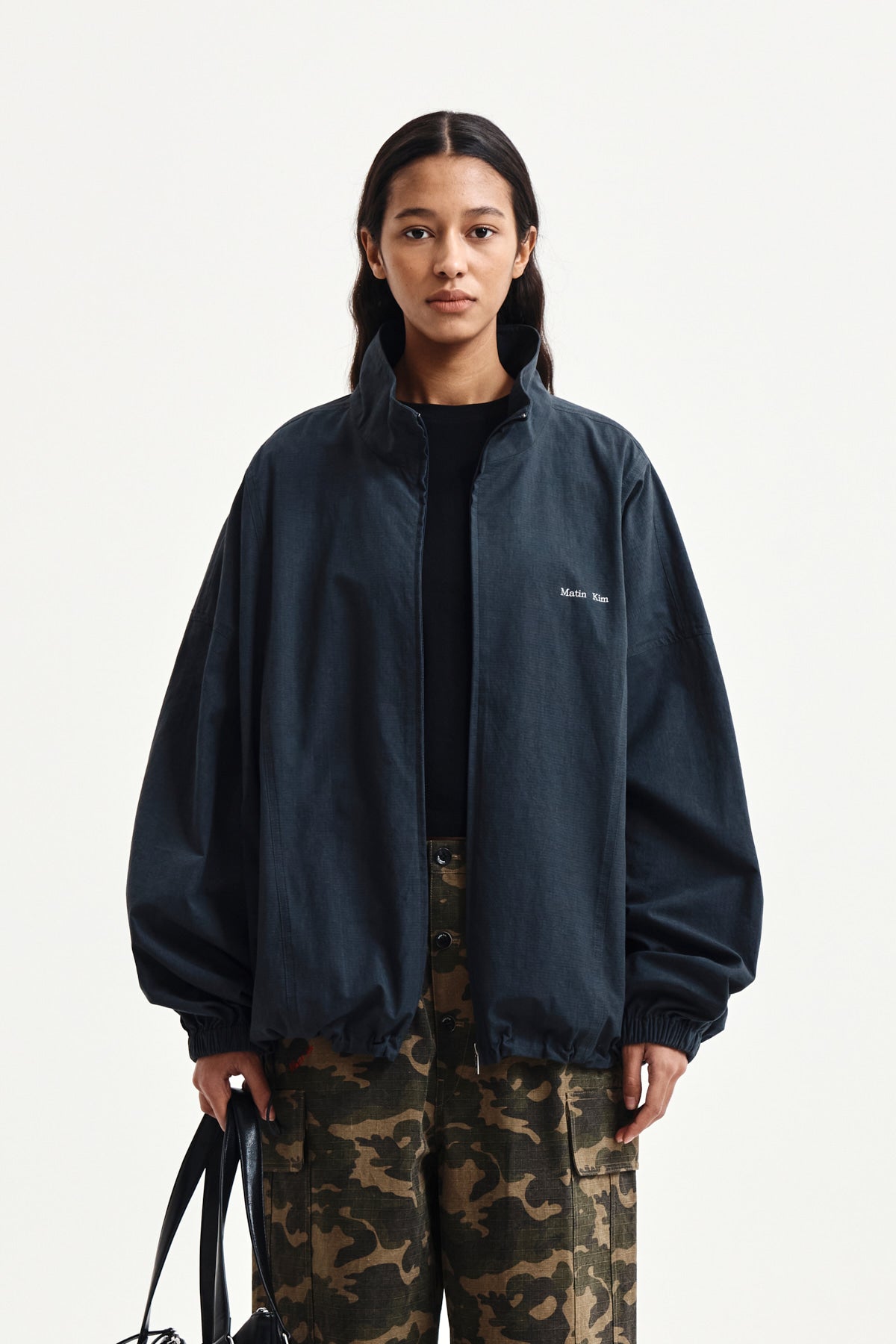 matinkim BACK LOGO HIGH NECK JUMPER IN CHARCOAL