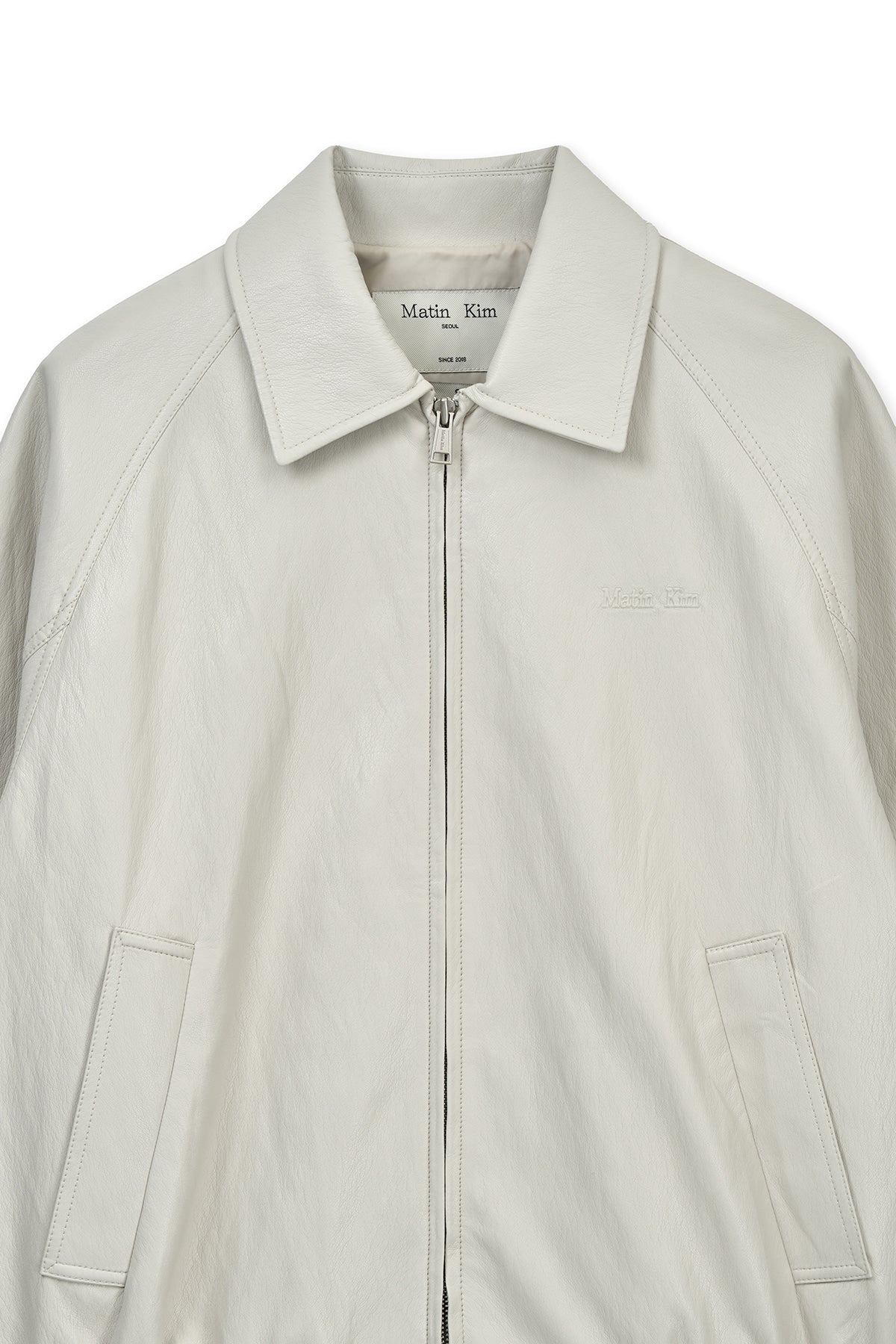 matinkim SMALL LOGO FAUX LEATHER ZIP UP JUMPER IN LIGHT GREY