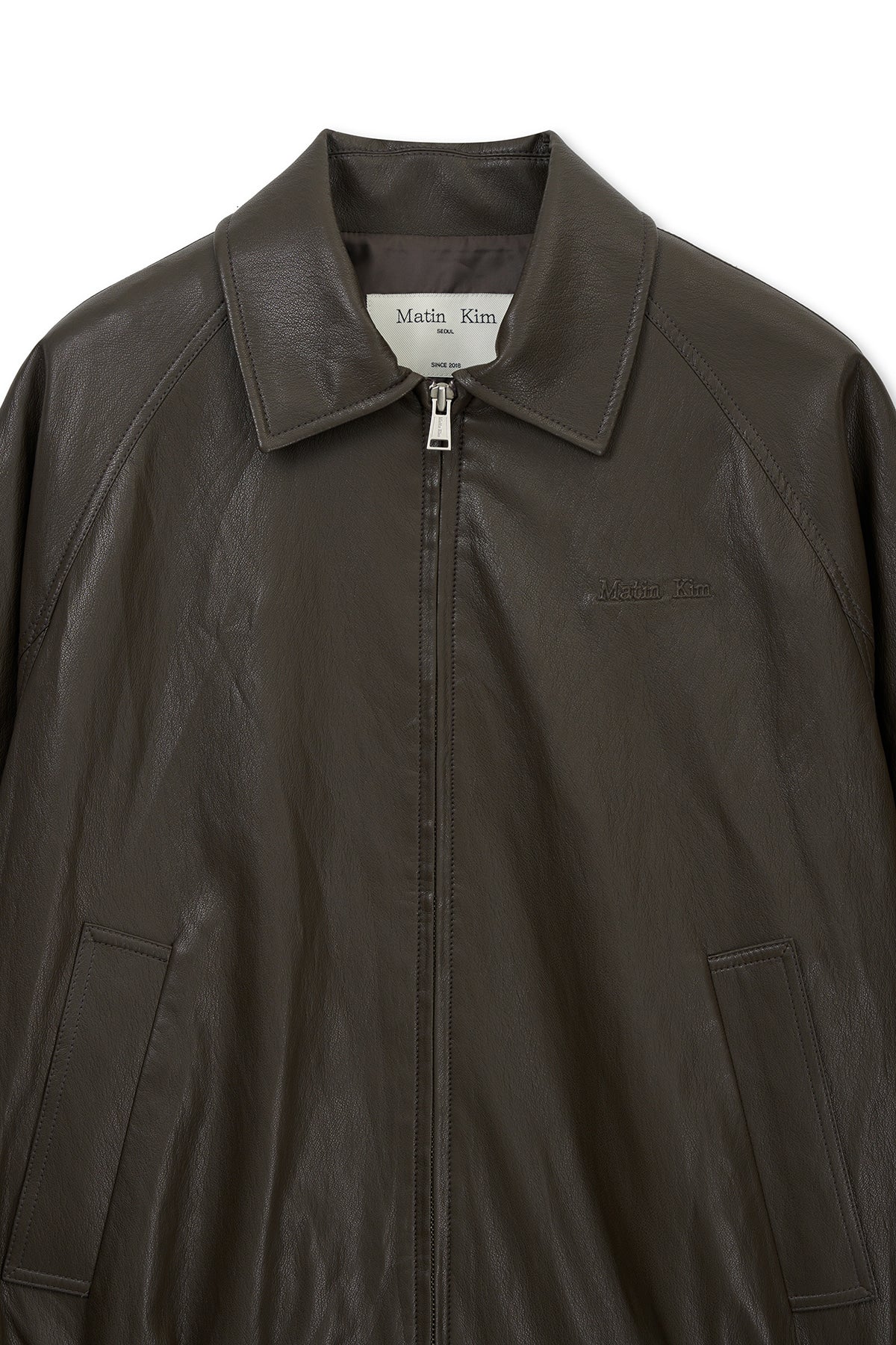 matinkim SMALL LOGO FAUX LEATHER ZIP UP JUMPER IN BROWN