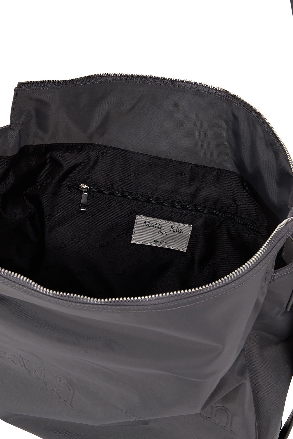 matinkim EMBOSSED LOGO FABRIC SHOULDER BAG IN CHARCOAL