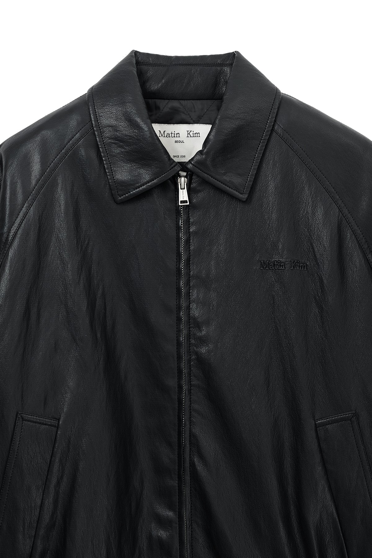 matinkim SMALL LOGO QUILTED FAUX LEATHER ZIP UP JUMPER IN BLACK