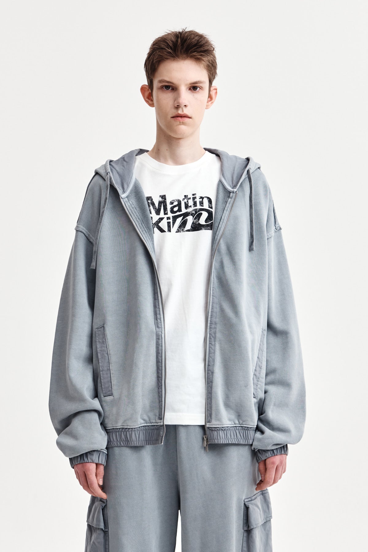 matinkim BACK LOGO PIGMENT DYED ZIP UP HOODY FOR MEN IN LIGHT GREY