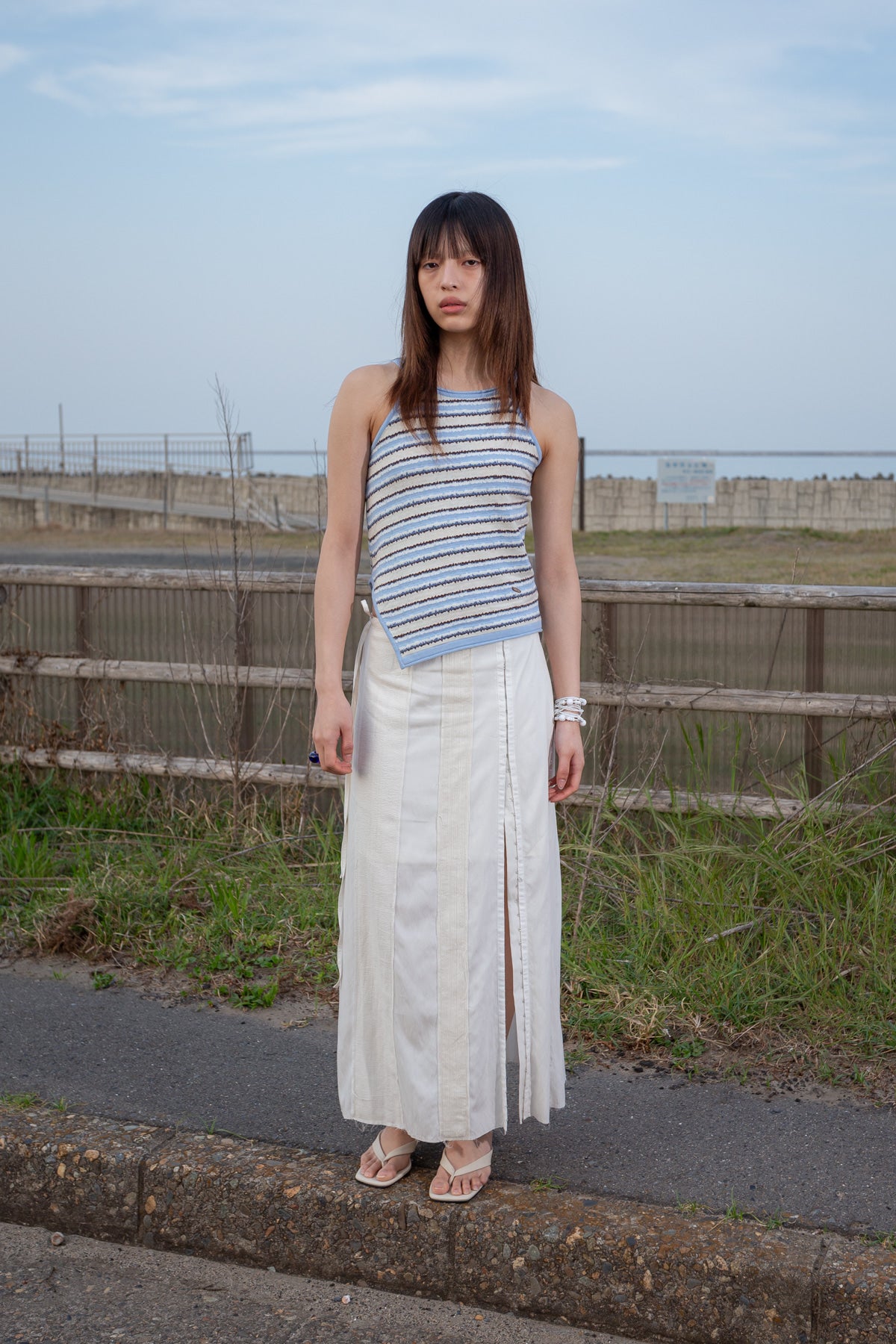 matinkim HOOK AND EYE STRING LONG SKIRT IN IVORY