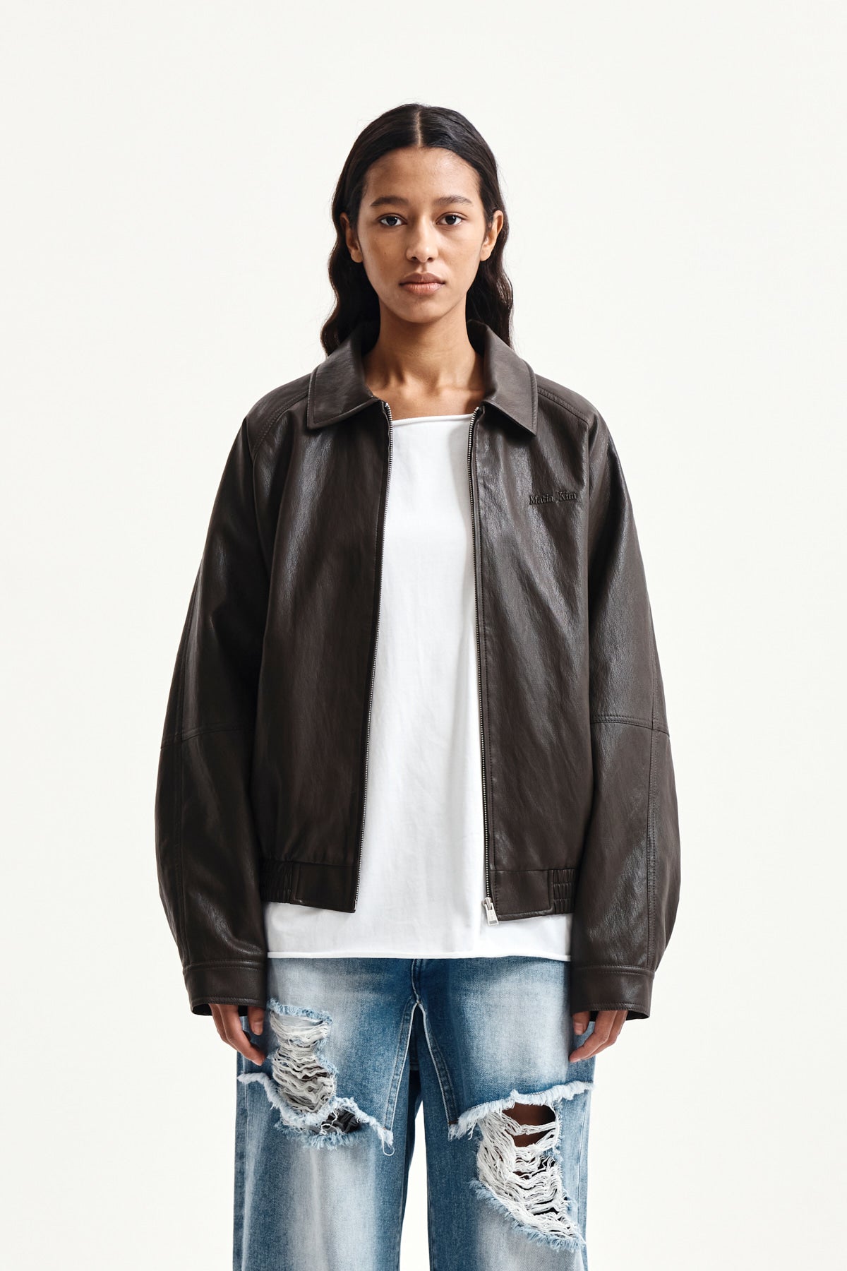 matinkim SMALL LOGO FAUX LEATHER ZIP UP JUMPER IN BROWN