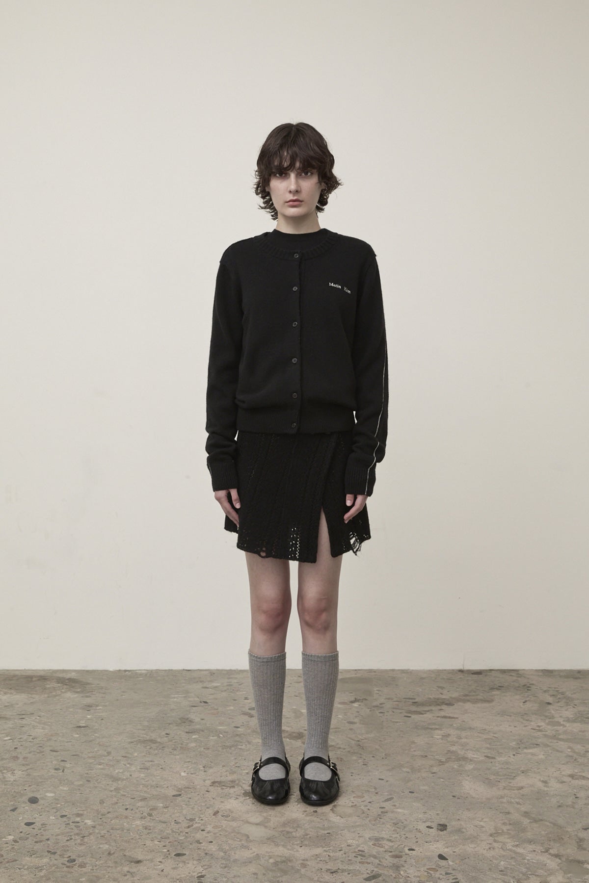 matinkim PUNCHING WRAP MINI SKIRT IN BLACK
